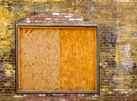 Old brick wall with boarded up window 스톡 사진