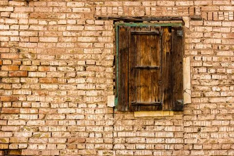 Old brick wall with boarded window, weathered texture Stock Photos