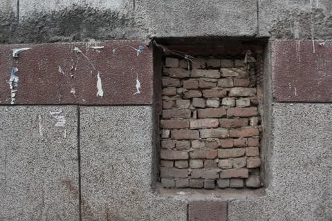 Old brick wall with brick filled window. 스톡 사진