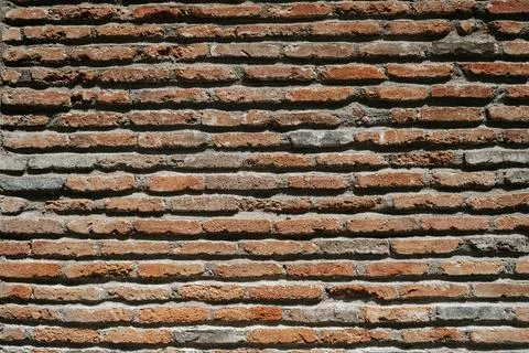 Old brick wall. Brickwork from an old brick in a rustic style. The structure and Stock Photos