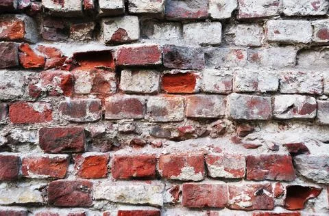 Old brick wall. Broken brick in the wall. Stock Photos