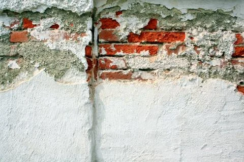 Old brick wall with broken plaster Stock Photos