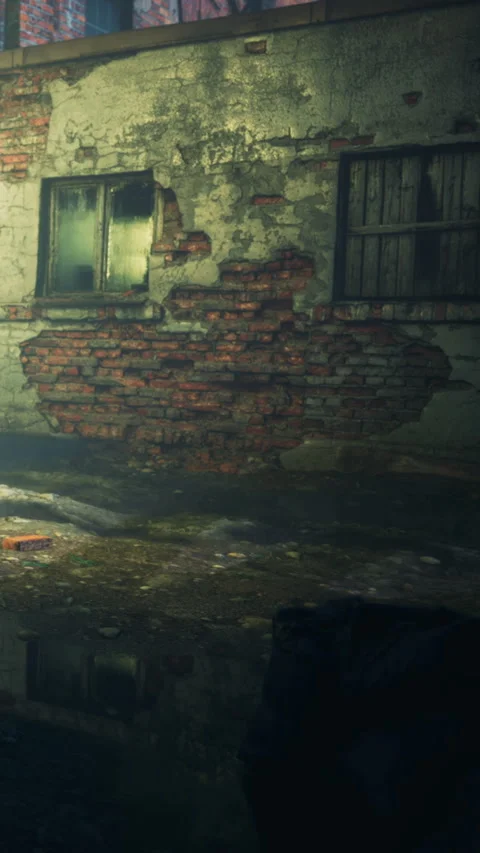 Old brick wall with broken windows and puddles on the ground in a city Stock Footage 343161953