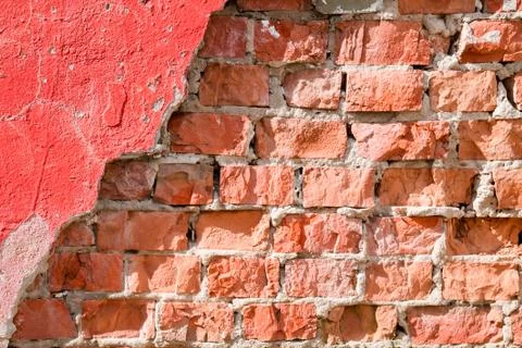 Old brick wall with chipped plaster. Background. Stock Photos
