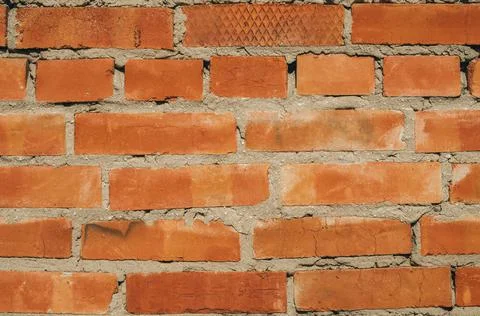 Old brick wall close-up. Background image with brick texture. Stock Photos