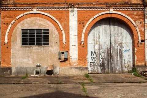 Old brick wall with closed gates Stock Photos