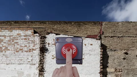 Old brick wall with clouds and hand pressing stop button Stock Footage 319963715
