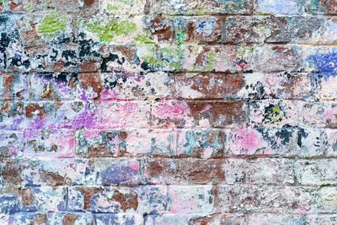 The old brick wall in colored paint. background Stock Photos