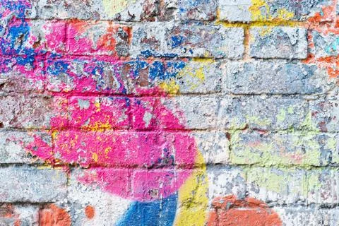 The old brick wall in colored paint. background Stock Photos