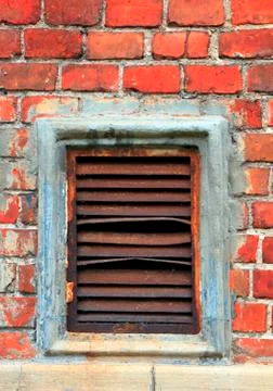 An old brick wall covered with moss. Old bricks red color Stock Photos