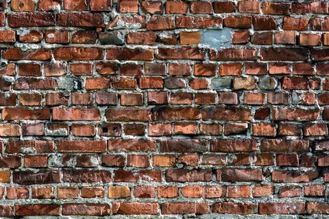 Old brick wall with cracked bricks showing architectural texture Фото