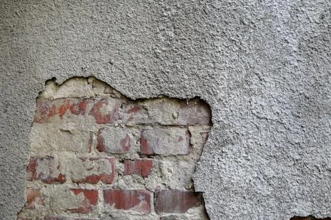 An old brick wall with gray plaster. Texture, background Stock Photos