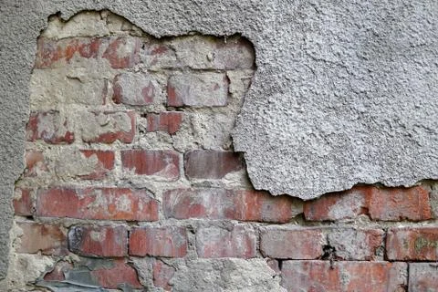 An old brick wall with gray plaster. Texture, background Stock Photos