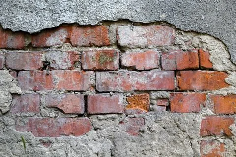 An old brick wall with gray plaster. Red brick. Texture, background Stock Photos