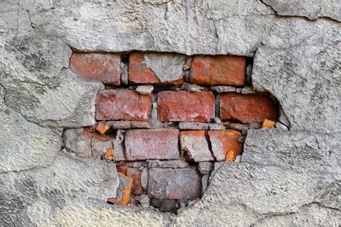 An old brick wall with gray plaster. Red brick. Texture, background Stock Photos