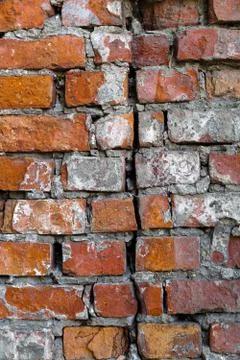 An old brick wall with gray plaster. Red brick. Foto stock