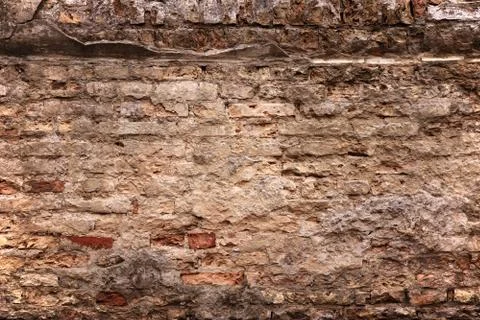 Old brick wall with loose bricks and deteriorating mortar Stock Photos