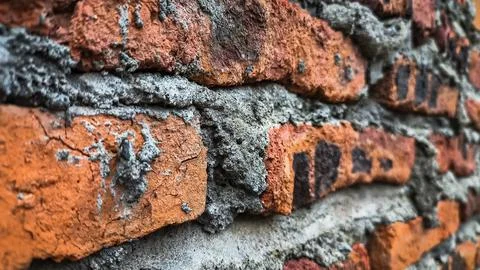 Old brick wall macro showing textured concrete seam and surface wear. Vinta.. Stock Photos
