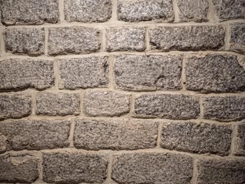 Old brick wall, old texture of gray stone blocks closeup Stock Photos