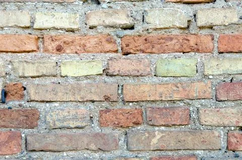 Old brick wall, old texture of red and orange blocks of stone. Closeup Stock Photos