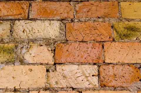 Old brick wall, old texture of red and orange blocks of stone. Closeup Stock Photos