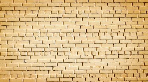 Old brick wall of orange blocks with wide cracks between them Stock Photos