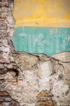 Old brick wall pattern closeup with fragments of letters Stock Photos