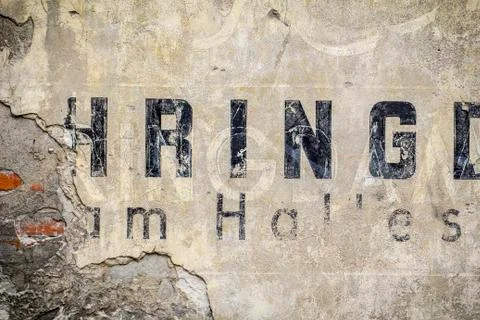 Old brick wall pattern closeup with fragments of letters Stock Photos