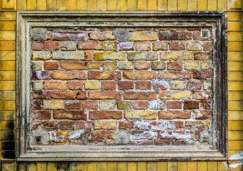 Old brick wall pattern closeup with stucco frame Stock Photos
