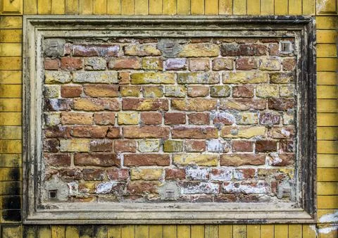Old brick wall pattern closeup with stucco frame Fotos de archivo