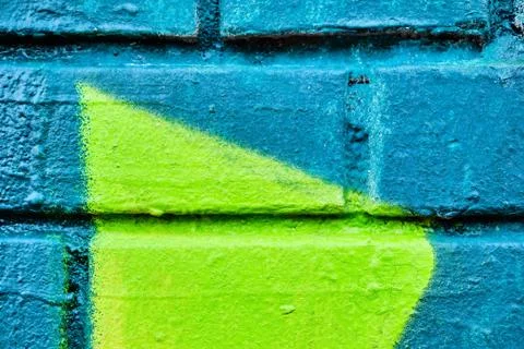 An old brick wall with a pattern of turquoise and green. Texture. Stock Photos