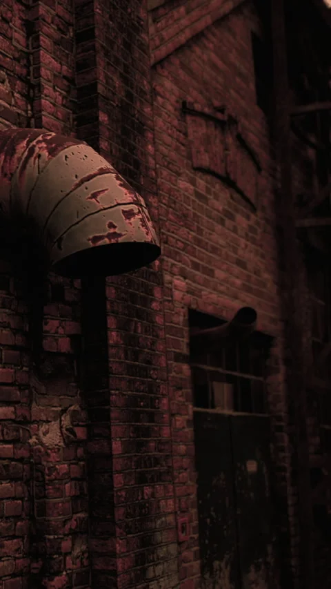 Old brick wall with a pipe and dark window at a factory site Stock Footage 346758866