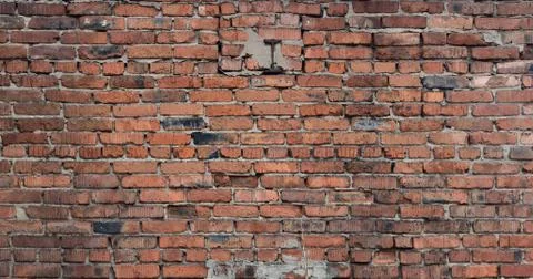 Old brick wall of red blocks with crumbling texture. Stock Photos