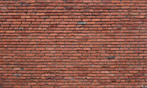 Old brick wall of red blocks with crumbling texture. Stock Photos