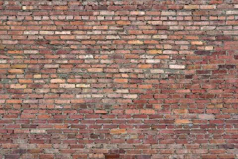 Old brick wall of red blocks with crumbling texture. Stock Photos
