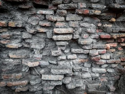Old brick wall with rough rustic texture, red mortar, and weathered surface Stock Photos