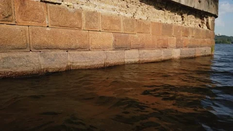 Old brick wall of ruined bridge pillar in the middle of the river Dnepr in Kiev Stock Footage 137328317