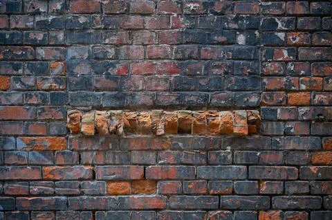Old brick wall, rustical chipped with spots. Grunge and urban texture. Stock Photos