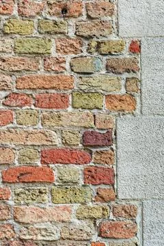 Old brick wall with stone blocks and plaster edge Stock Photos