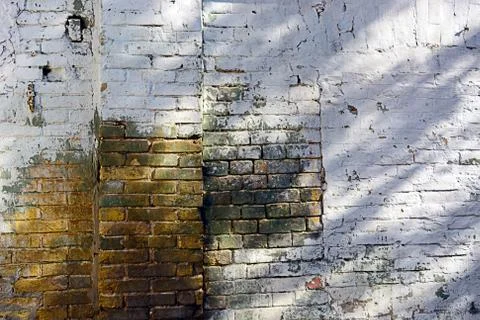 Old brick wall texture background with worn off paint Stock Photos
