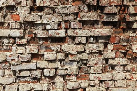 Old brick wall texture. The wall, made of old red bricks, darkened by old age Stock Photos