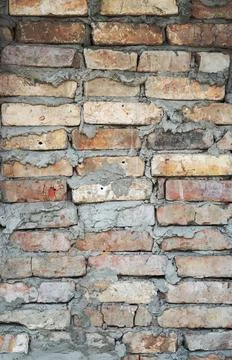 Old brick wall texture. The wall, made of old red bricks, darkened by old a.. Stock Photos
