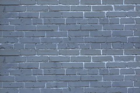 Old brick wall with a thick layer of paint Stock Photos