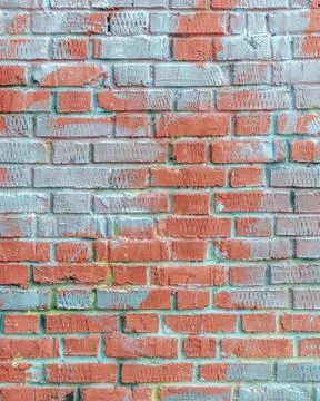 Old brick wall with traces of paint. Stock Photos