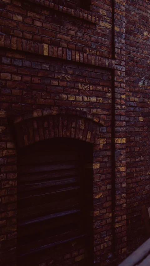 Old brick wall in urban area during daylight hours with clear sky above Stock Footage 334884116