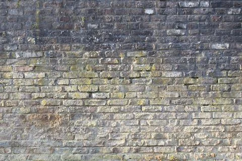 An old brick wall weathered with missing cement joints Stock Photos