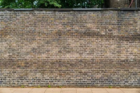 Old brick wall with weathered texture captured in natural daylight. The sur.. Stock Photos