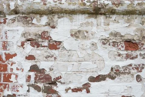 An old brick wall where the plaster is falling off. Background, texture. Stock Photos