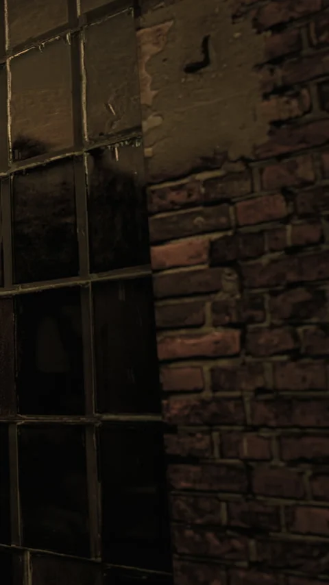 Old brick wall with window and shadows in a dimly lit room at night Stock Footage 334261511