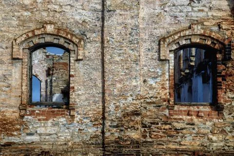 Old brick wall with windows of abandoned building. Grunge background of aged Stock Photos